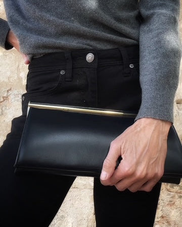 Navy leather clutch, gold bar frame detail, structured top handle — BB Vintage by Maxine