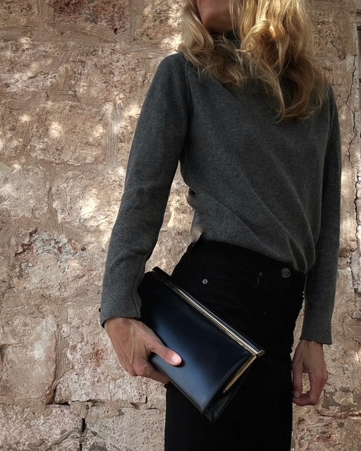 Vintage navy frame clutch, back view, sleek leather finish 